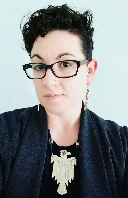 Image of caucasian woman with short black hair in black framed glasses on white background